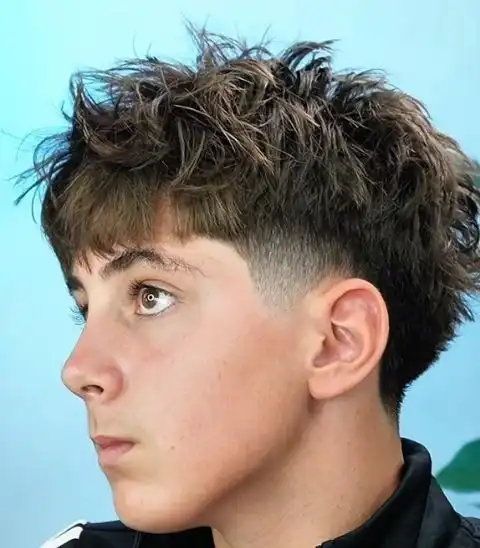 Barber using scissors to shape and cut a client's hair