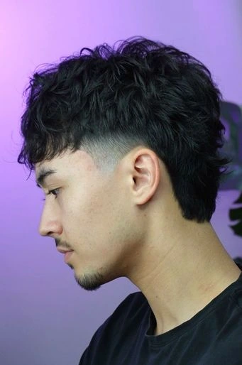 Pat Barber focused while cutting hair with attention to detail