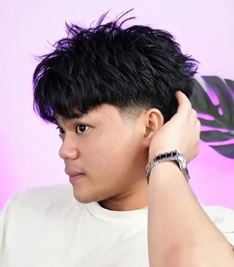 Front view of a high taper fade with a styled top