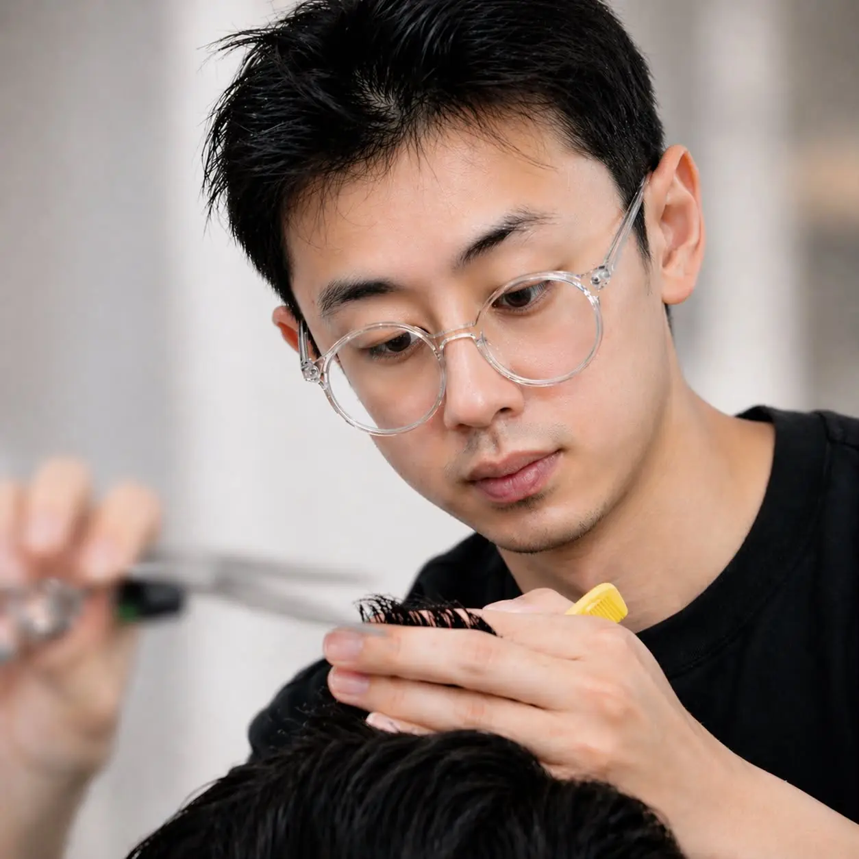Pat cutting a client's hair at Pat Barber, Springvale